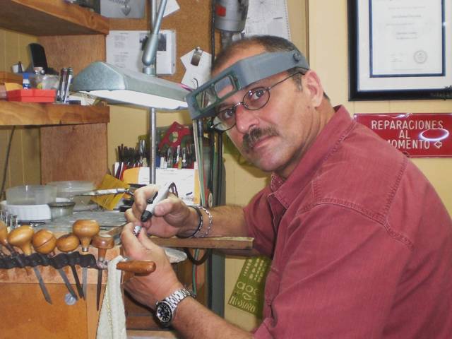 A jeweler at work on the CACHO workbench
